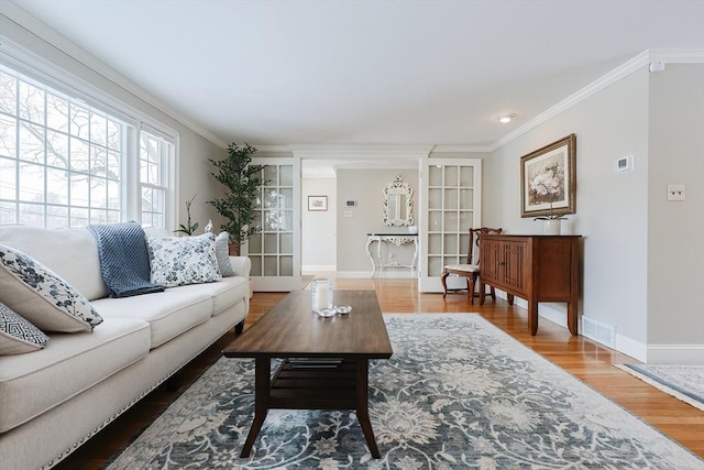 living room featuring hardwood / wood-style flooring and ornamental molding