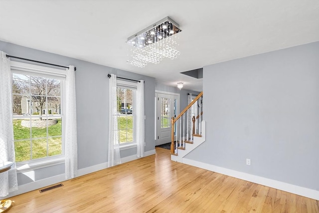 29 Regatta Dr, Attleboro, MA 02703 - entryway featuring stairs, visible vents, baseboards, and wood finished floors