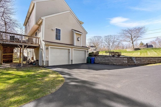 29 Regatta Dr, Attleboro, MA 02703 - view of side of home with a garage, a wooden deck, and aphalt driveway