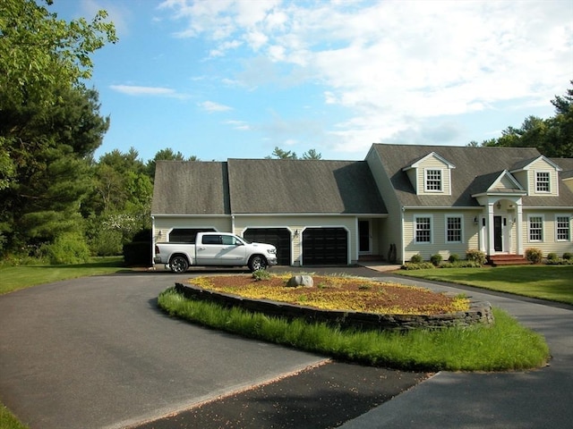 cape cod home with a garage