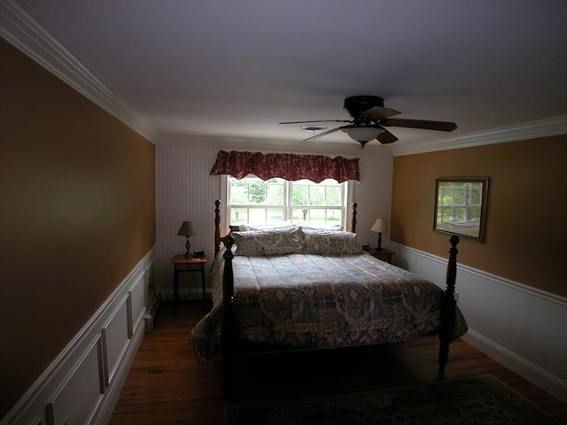 bedroom with crown molding, ceiling fan, and dark hardwood / wood-style flooring