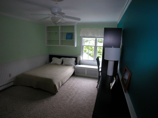 carpeted bedroom with ceiling fan, baseboard heating, radiator, and crown molding