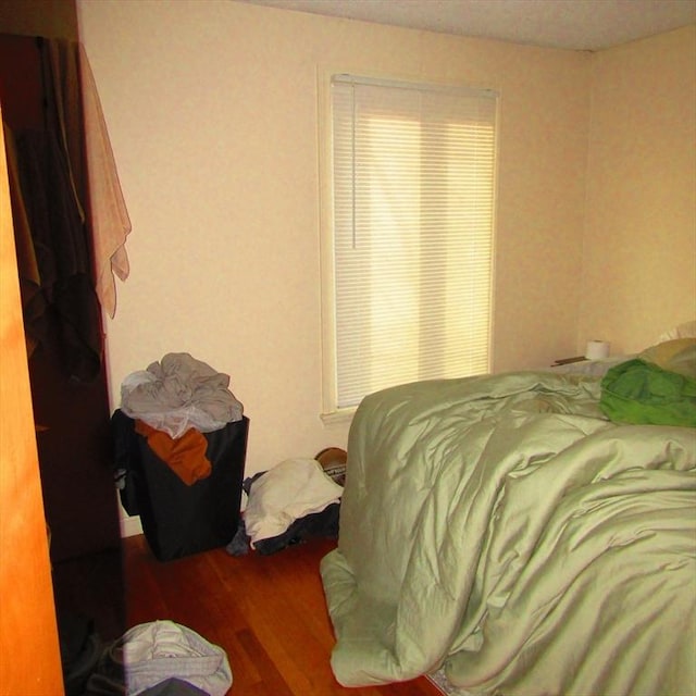 bedroom with wood-type flooring