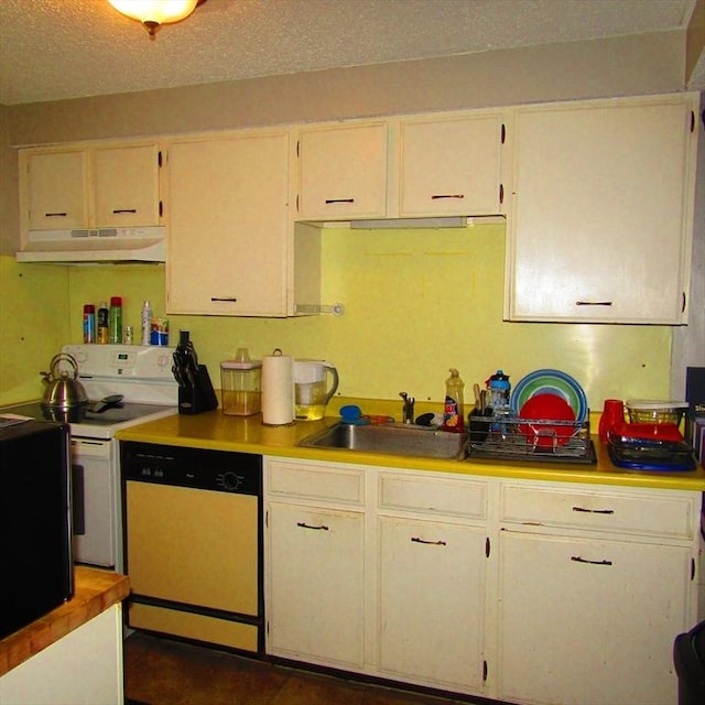 kitchen with a textured ceiling, white appliances, white cabinetry, and sink