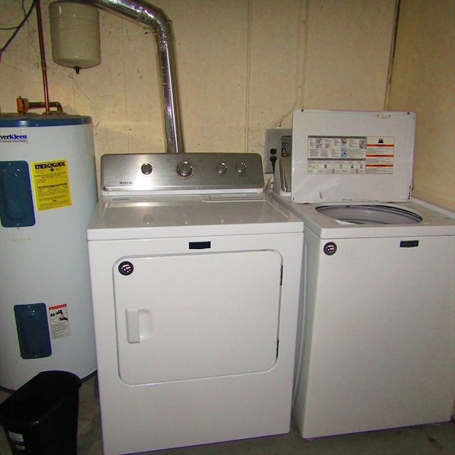 laundry area with washing machine and dryer and water heater