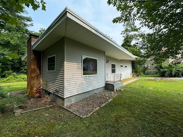 view of property exterior featuring a lawn