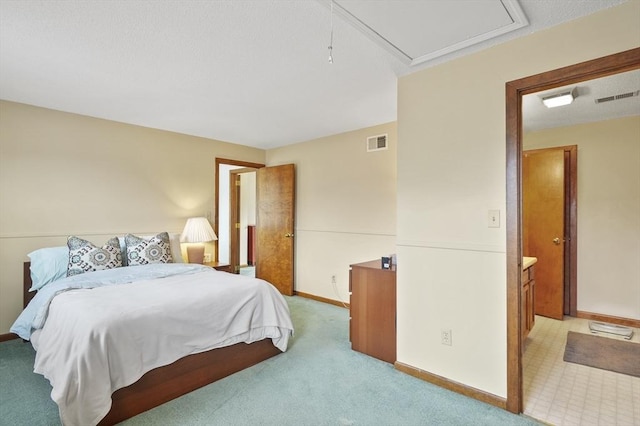 bedroom with baseboards, light carpet, visible vents, and attic access