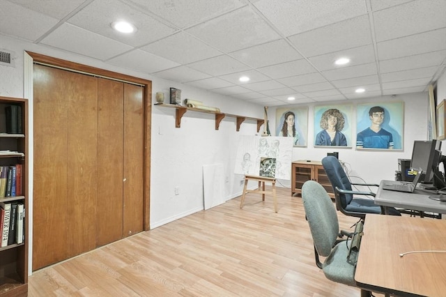 office featuring light wood-type flooring, a paneled ceiling, and recessed lighting