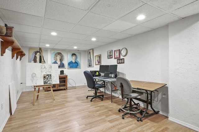 home office featuring recessed lighting, a drop ceiling, wood finished floors, and baseboards