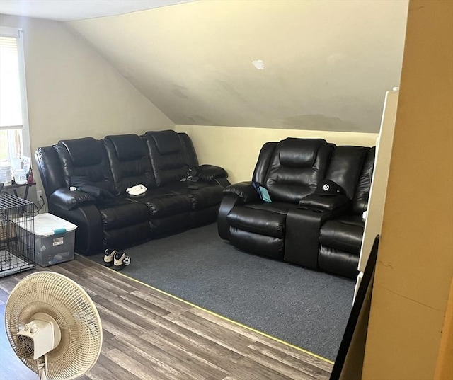 home theater room with lofted ceiling and wood-type flooring