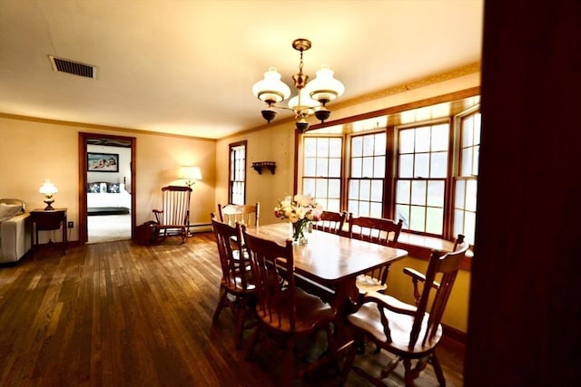dining area featuring hardwood / wood-style floors, a chandelier, baseboards, visible vents, and crown molding