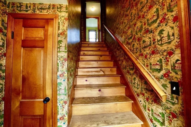 staircase featuring wallpapered walls
