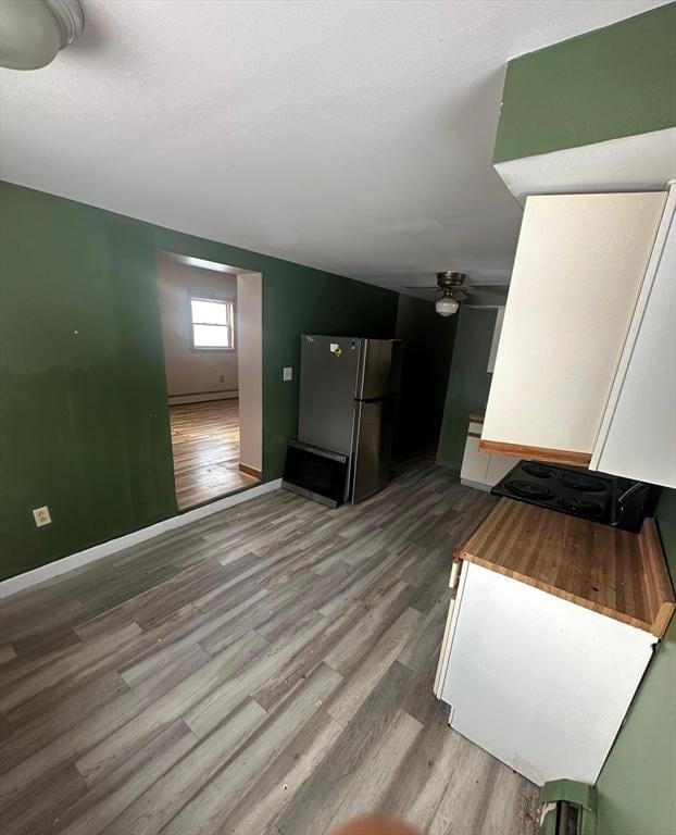 unfurnished living room with ceiling fan and light wood-type flooring