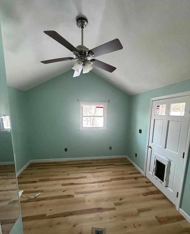 interior space with light hardwood / wood-style flooring, ceiling fan, and vaulted ceiling