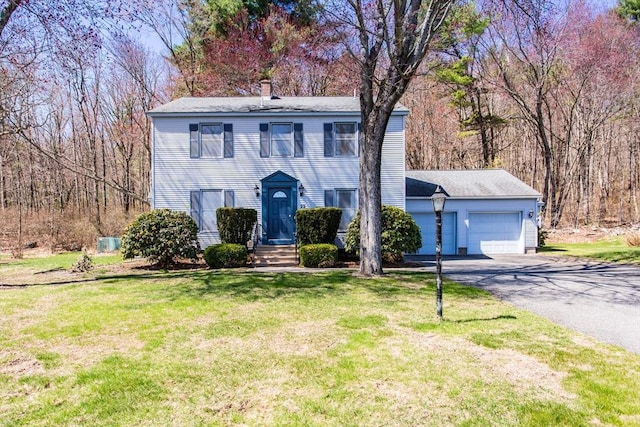 22 Berkshire Cir, Ware, MA 01082 - colonial inspired home with a chimney, asphalt driveway, an attached garage, and a front yard