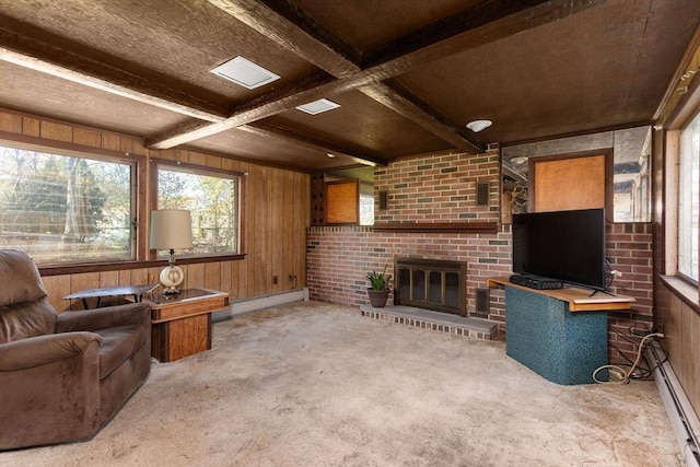 carpeted living room with plenty of natural light, a baseboard radiator, and wooden walls