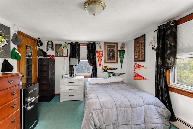 carpeted bedroom with baseboard heating