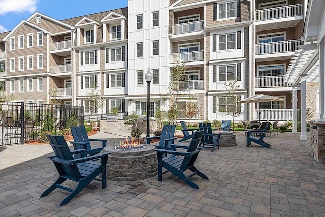 view of community featuring fence and a fire pit