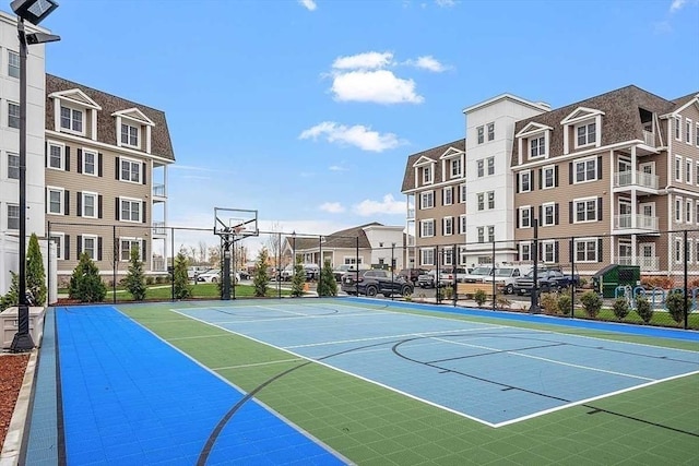 view of basketball court featuring fence and community basketball court