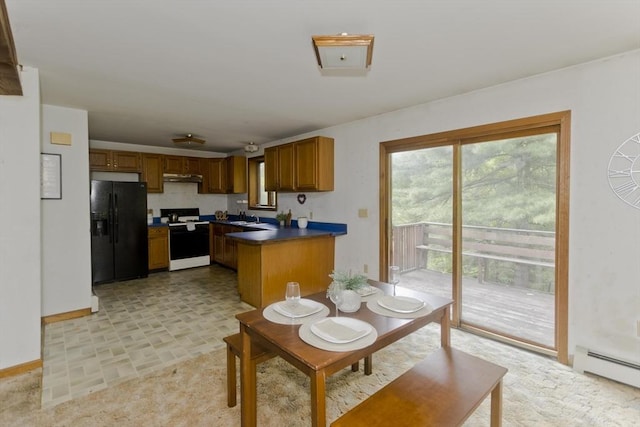 245 State Rd, Phillipston, MA 01331 - kitchen with black refrigerator with ice dispenser, range, under cabinet range hood, dark countertops, and a baseboard heating unit
