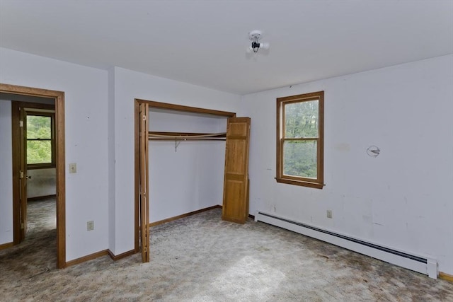 245 State Rd, Phillipston, MA 01331 - unfurnished bedroom featuring baseboard heating, multiple windows, light colored carpet, and a closet