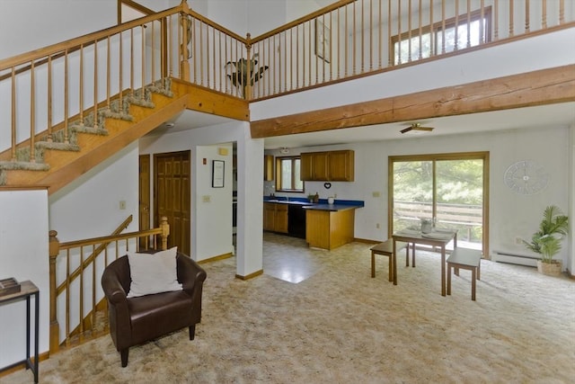 245 State Rd, Phillipston, MA 01331 - living area with light carpet, a baseboard heating unit, a high ceiling, and stairway