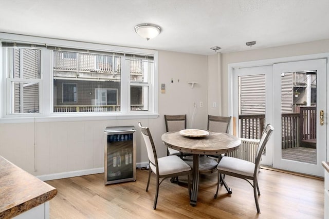 13 Knowlton St, Boston, MA 02127 - dining room featuring light wood finished floors, baseboards, and beverage cooler