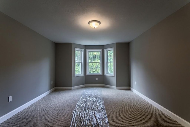 unfurnished room featuring light colored carpet