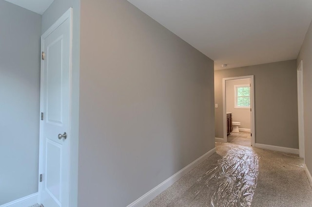 hallway featuring light carpet