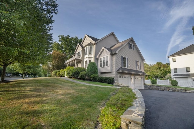 view of front of house with a front yard and a garage