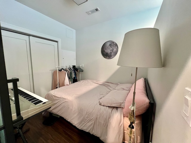 bedroom with hardwood / wood-style flooring and a closet