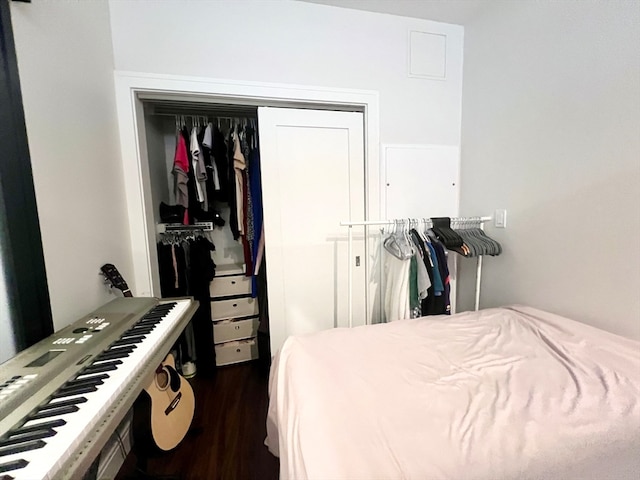 bedroom with dark hardwood / wood-style flooring and a closet