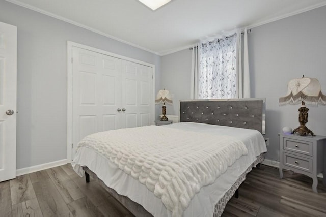 bedroom with dark hardwood / wood-style flooring, a closet, and ornamental molding