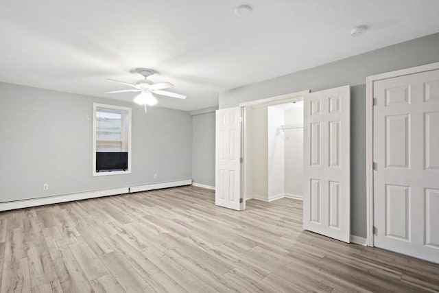 unfurnished bedroom with ceiling fan, baseboard heating, and light hardwood / wood-style floors