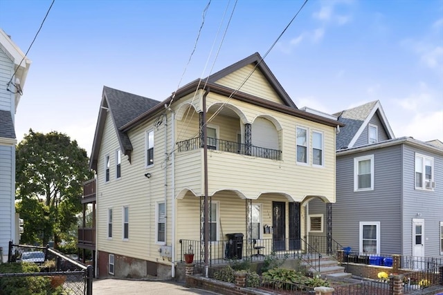127-129 Franklin St, Malden, MA 02148 - view of property featuring covered porch, a balcony, and a shingled roof