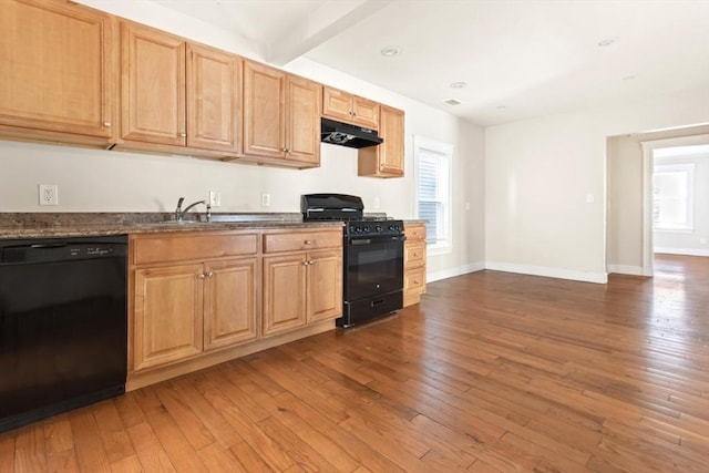 127-129 Franklin St, Malden, MA 02148 - kitchen with black appliances, under cabinet range hood, hardwood / wood-style floors, baseboards, and beam ceiling