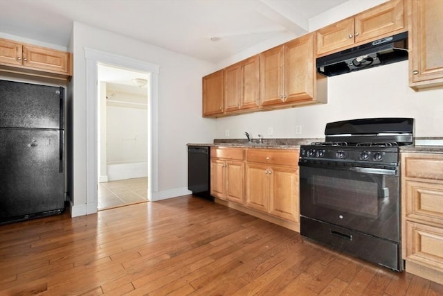 127-129 Franklin St, Malden, MA 02148 - kitchen featuring black appliances, under cabinet range hood, dark wood-type flooring, and a sink