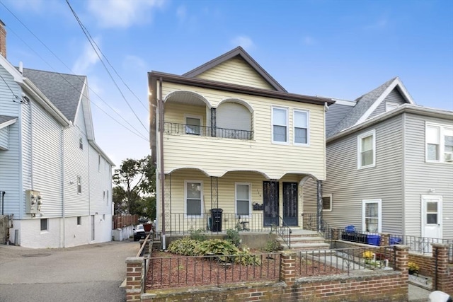 127-129 Franklin St, Malden, MA 02148 - multi unit property featuring covered porch, a fenced front yard, and a balcony