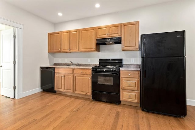 127-129 Franklin St, Malden, MA 02148 - kitchen featuring black appliances, under cabinet range hood, light wood-style flooring, light countertops, and a sink