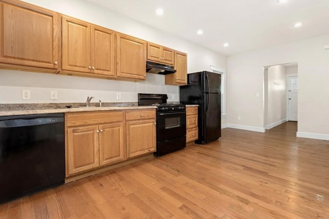 127-129 Franklin St, Malden, MA 02148 - kitchen featuring black appliances, under cabinet range hood, a sink, light wood finished floors, and baseboards
