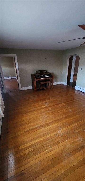 interior space featuring hardwood / wood-style floors and a baseboard heating unit