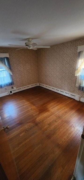 unfurnished room with hardwood / wood-style flooring