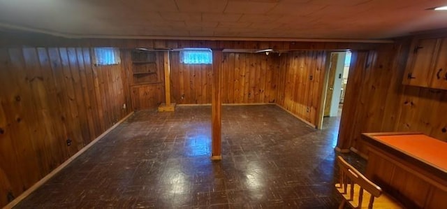 basement featuring wooden walls