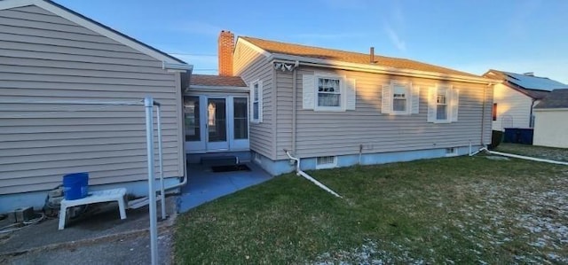 view of side of property with a lawn