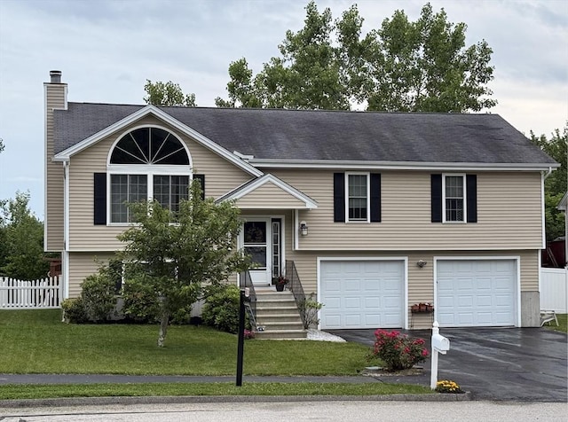 5 Holly Ter, Worcester, MA 01607 - raised ranch with a garage, asphalt driveway, and a chimney