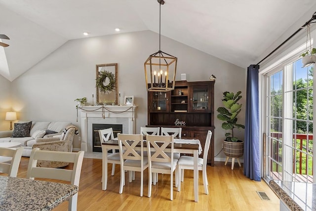 5 Holly Ter, Worcester, MA 01607 - dining area featuring lofted ceiling, light wood-type flooring, a fireplace with flush hearth, and ceiling fan