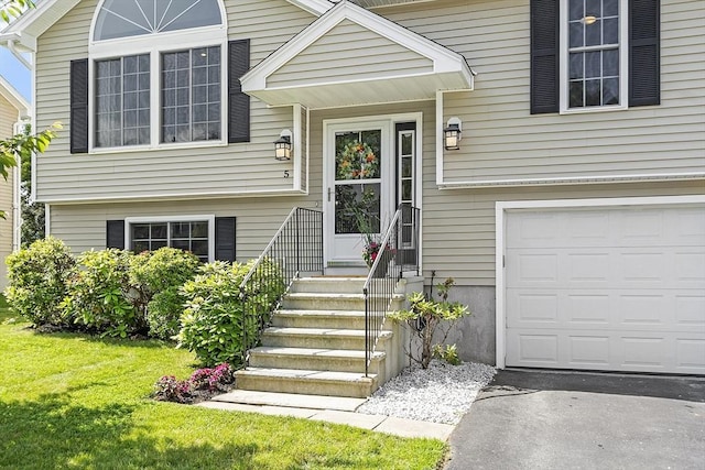5 Holly Ter, Worcester, MA 01607 - view of exterior entry with a garage and a lawn