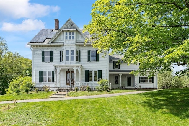 267 Pearl Hill Rd, Fitchburg, MA 01420 - victorian house featuring solar panels, a chimney, and a front lawn