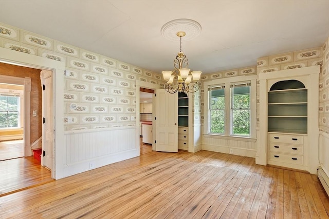267 Pearl Hill Rd, Fitchburg, MA 01420 - unfurnished dining area with light wood finished floors, a chandelier, and a baseboard heating unit