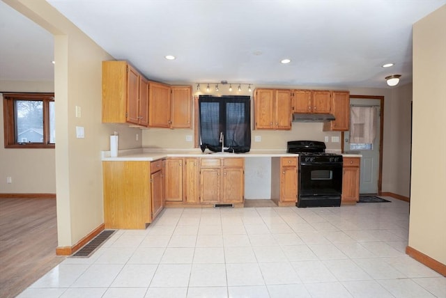 30 Royal St, Randolph, MA 02368 - kitchen with black gas stove, baseboards, light countertops, under cabinet range hood, and recessed lighting